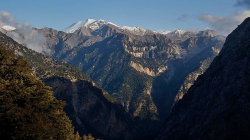High, rocky mountains with snow-covered peaks under a clear sky, Lefka Ori, Omalos Plateau,