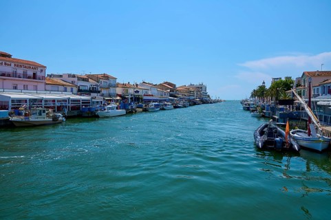 Coastal town with colourful houses, boats in the water, on a sunny day, summer, Le Grau-du-Roi,