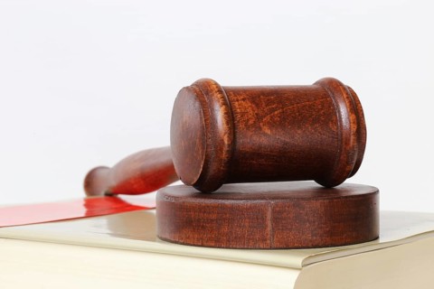 Book and judge's gavel as a symbolic image for a court judgement