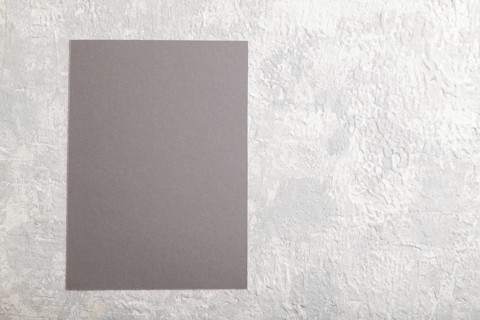 Gray paper business card, mockup on gray concrete background. Blank, flat lay, top view, still