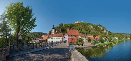 Bridge with the statue of St Nepomuk over the river Naab in a peaceful atmosphere with a view of