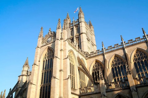 English flag flying on the tower of the Abbey church, Bath, Somerset, England, United Kingdom,
