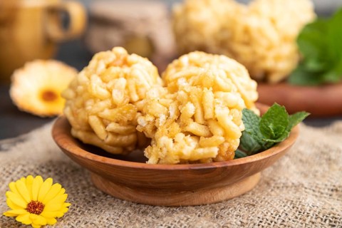 Traditional Tatar candy chak-chak made of dough and honey with cup of coffee on a black concrete