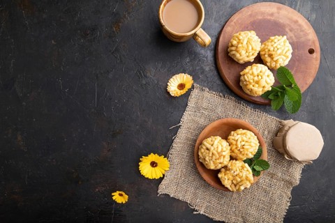 Traditional Tatar candy chak-chak made of dough and honey with cup of coffee on a black concrete