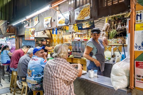 Visitors sitting at a food stall at the counter, Mercado Central de San José, San José, Costa Rica,