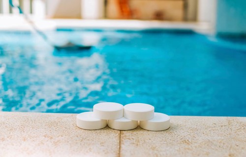 Chlorine tablets for swimming pool cleaning. close up of chlorine tablets on the edge of a swimming