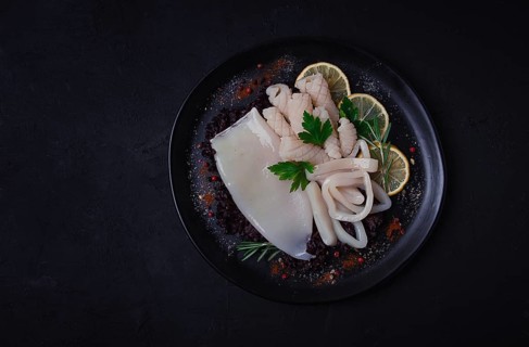 Fresh squid, raw, carcass, cut into rings, top view, no people