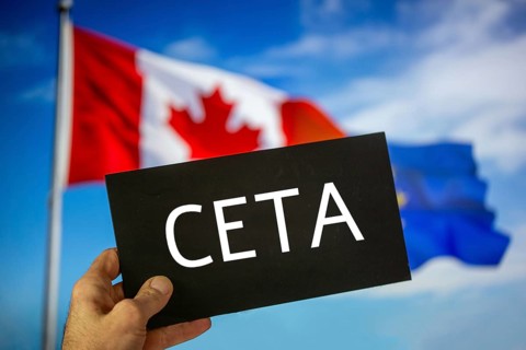 Sign reading CETA in front of the flags of Canada and the European Union. The abbreviation CETA