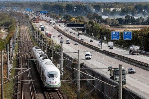 A Deutsche Bahn ICE train passes cars on the A3 motorway, Flörsheim, 28/09/2020