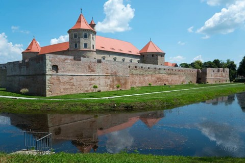 Medieval castle with red roofs, surrounded by a moat with a reflection, fortress, Fagaras, Fagara?,