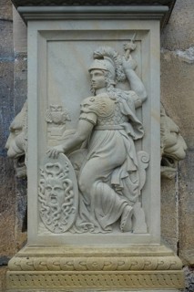 Relief, stone figure, female figure warrior with helmet and shield at the gate portal, lower castle