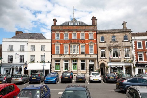 Lloyds Bank Limited building and shops in the Market Place, Devizes, Wiltshire, England, United