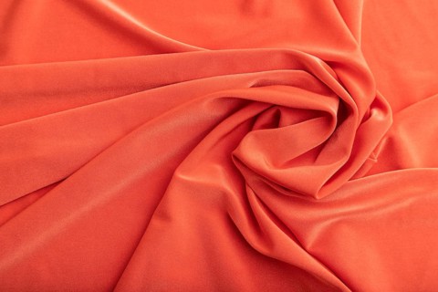 Fragment of red linen tissue. Top view, flat lay, natural textile background and texture. wave