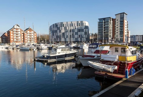 University of Suffolk waterfront buildings boats moored in marina, Ipswich Wet Dock waterside
