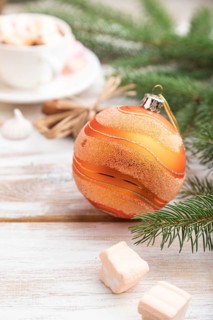 Christmas or New Year composition. Decorations, box, balls, cinnamon, fir and spruce branches, cup
