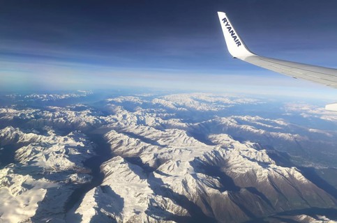 View from plane of snow covered mountain peaks in the Alps between France and Italy