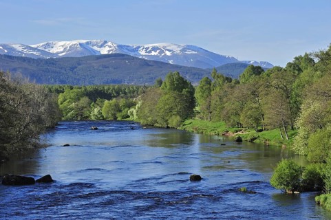The River Spey near Aviemore and the Cairngorm mountains covered in snow, Badenoch and Strathspey,