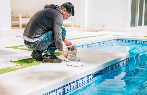 Man cleaning swimming pool filter basket. Person cleaning garbage filter basket for swimming pool