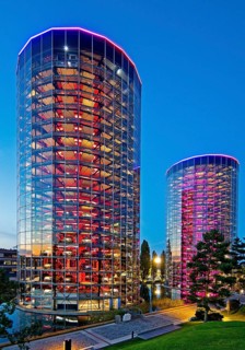 The illuminated car towers with new cars for delivery in the evening, Autostadt, Volkswagen AG,