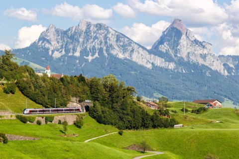 Railway passenger train of the type Stadler Flirt of the Südostbahn on the mountain Großer Mythen