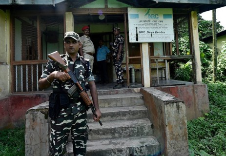 Security personnel keep vigil outside the office of National Register of Citizens (NRC) in the eve
