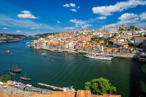 Aerial view of Porto city and Vila Nova de Gaia and Douro river with moored sailling ship from Dom