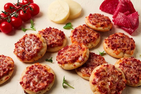 Mini pizzas, salami with mozzarella cheese, on a white table, top view, no people