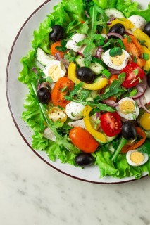 Vegetable salad, with quail eggs and olives, fresh, close-up, no people
