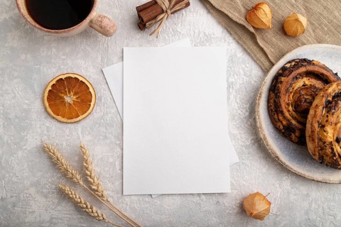 White paper invitation card, mockup with ear of wheat, bun, cup of coffee, linen textile, physalis