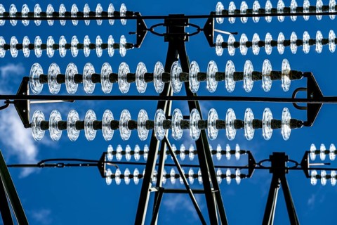 Insulators made of glass on a high-voltage line, they hang on the pylons as a suspension device