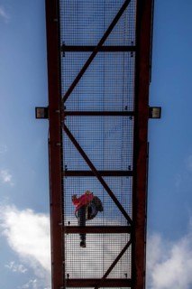 Lattice walkway, people walk over a walkway at a height of a good 15 metres, made of steel lattice,