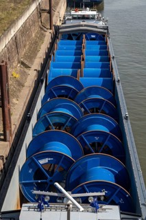 Freighter at the harbour canal, inland port Duisburg-Ruhrort, cargo ship, loaded with empty cable