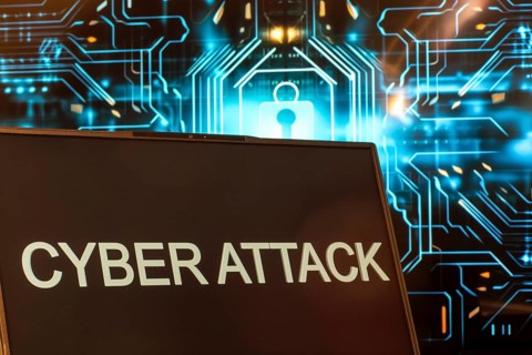 Cyber attack symbol: Laptop in front of a virtual computer background