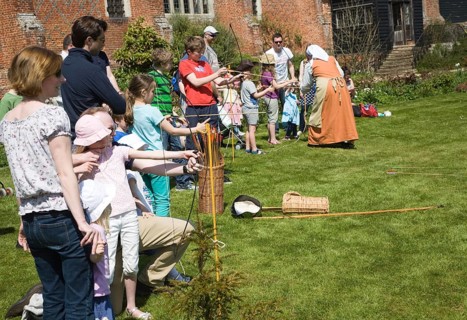 Children archery lesson during Tudor history day at Layer Marney, Essex, England, United Kingdom,