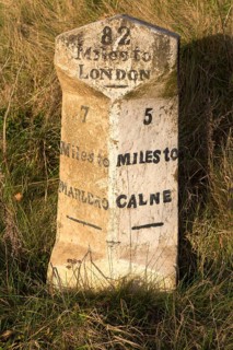 Old milestone road marker on A4 road Beckhampton, Wiltshire, England, UK