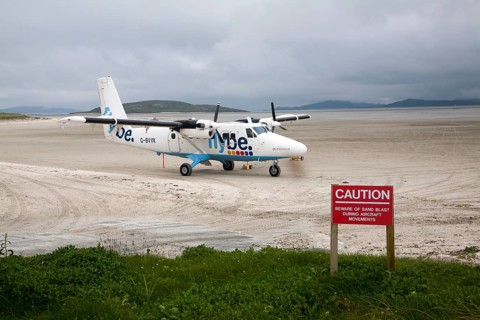 Flybe plane on sandy airstrip Isle of Barra airport, Barra, Outer Hebrides, Scotland, UK