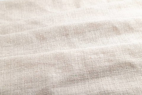 Fragment of white linen tissue. Side view, natural textile background and texture. wave concept,