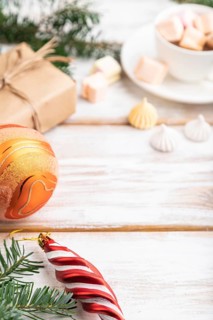 Christmas or New Year composition. Decorations, box, balls, cinnamon, fir and spruce branches, cup
