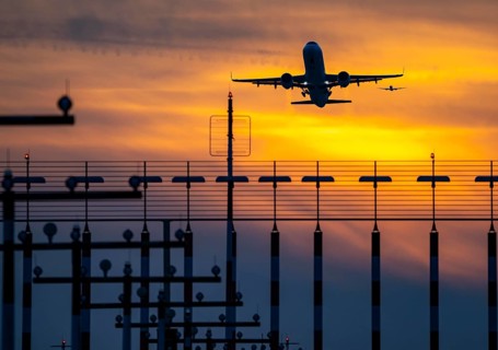 Runway lighting, approach aids, at Düsseldorf International Airport, sunset, aircraft taking off