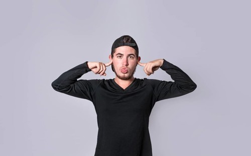 Man covering his ears isolated, guy covering his ears on isolated background, man with hands on his