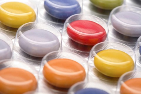 Colourful tablets packed in plastic, tablet addiction, drug addiction, studio