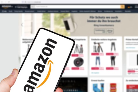Amazon logo online marketplace online trading ecommerce on a mobile phone and computer in