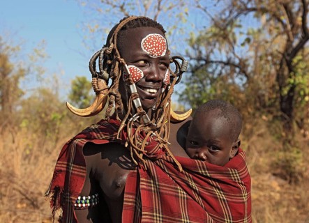 South Ethiopia, in Maco National Park, Mursi tribe, Mursi woman with baby, painted skin and