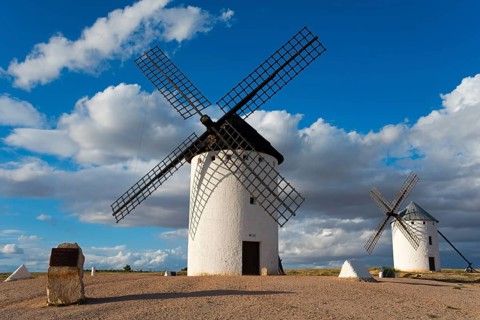 Windmill in a rural setting under a blue sky with dramatic clouds, windmills, Campo de Criptana,