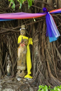 Buddhist figure in front of a tree on Phi Phi Island, wood, carving, wooden figure, Buddhism,