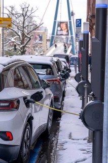Winter in the city, electric cars charging at charging stations in the city centre of Frankfurt,