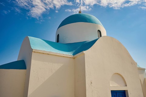 Close-up of a white church with a blue dome under a blue sky, Church of Profitis Ilias, above