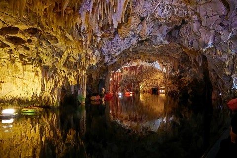 Cave interior with water, stalactites on the ceiling and boats, stalactite cave, Diros Cave,