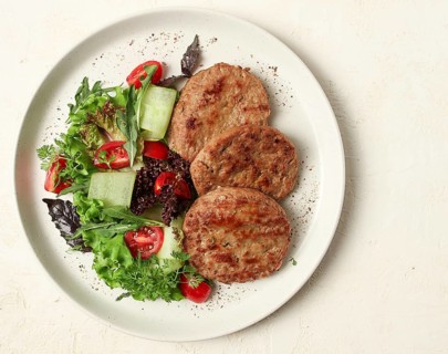 Fried cutlets, minced beef, with vegetable salad, top view, no people