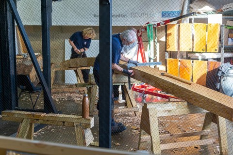 Craftsmen working on reconstruction of Anglo-Saxon ship from Sutton Hoo, Longshed building,